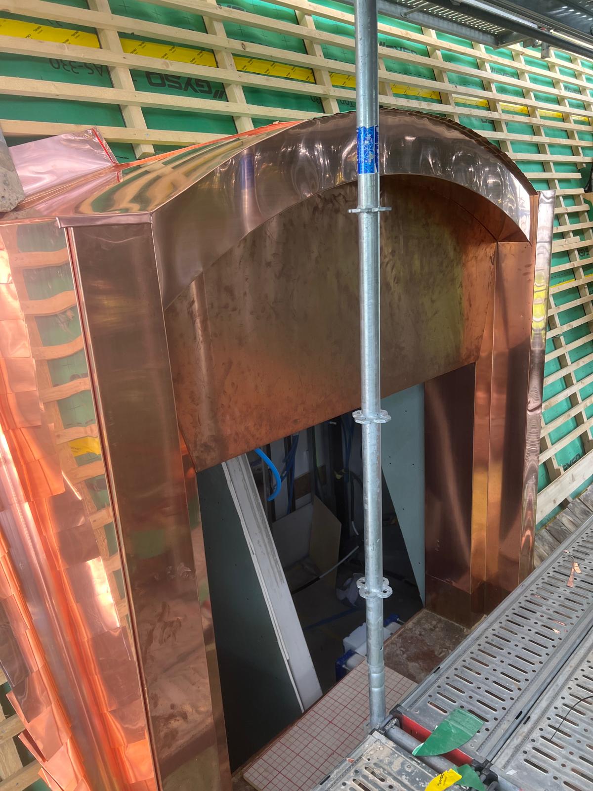 Lucarne ronde habillée en cuivre sur une toiture
